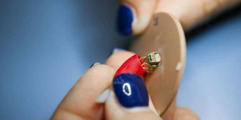 Electronic componants being inserted into a hearing aid shell.